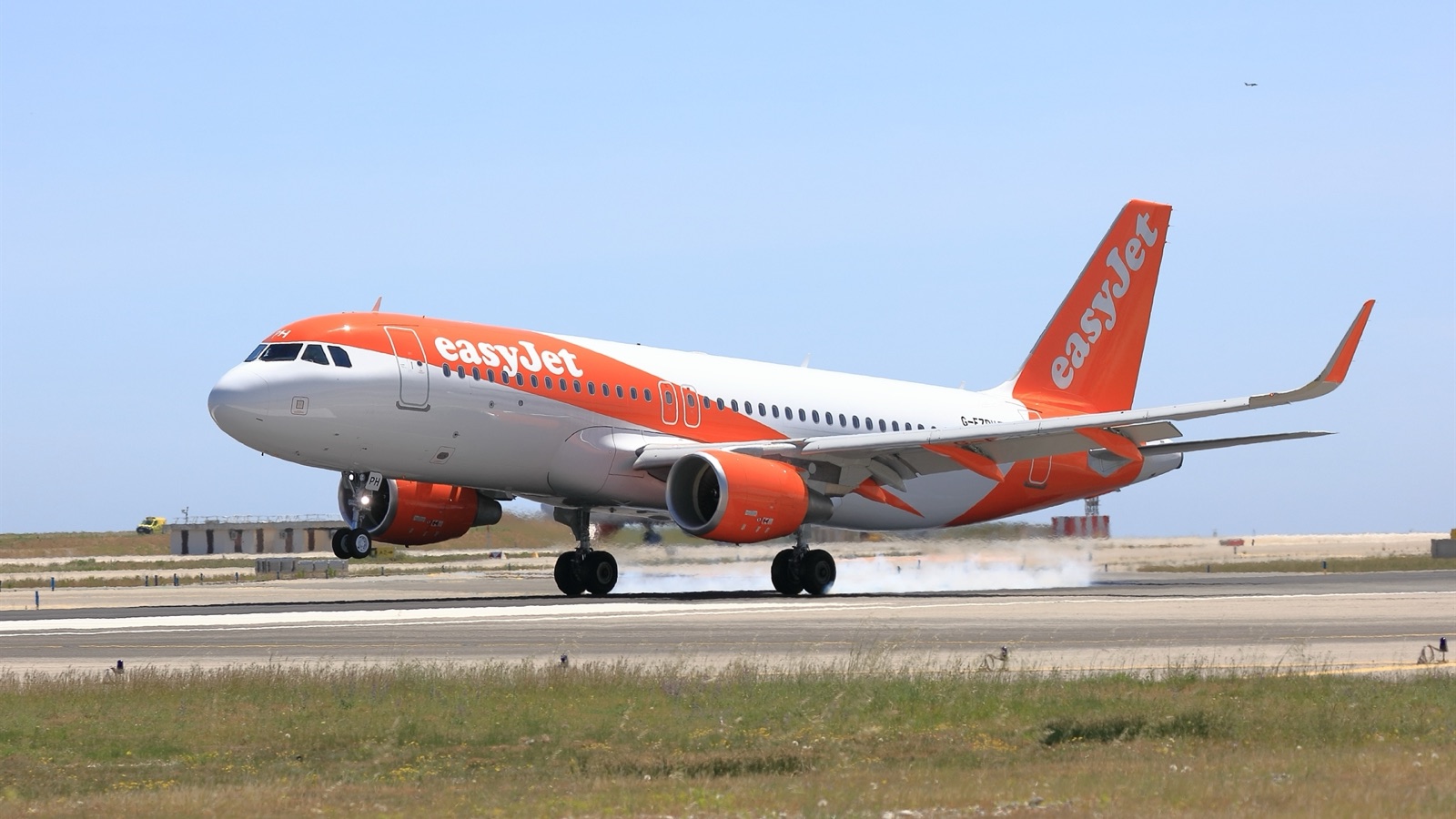 easyJet: Airbus A320 (sharklets) exterior, touching down, front three-quarter view, current livery